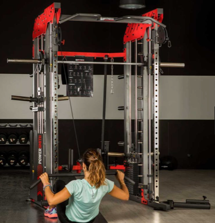 BH G145 Light Commercial Power Smith With Dual 90kg Weight Stacks showing female model performing Lat Pulldown from a single pulley