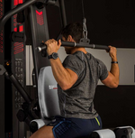 Image of a person using the lat pulldown station on the BH Indar multi station gym.  