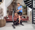 Flow Fitness DHT 2000i Upright Bike with male rider in room setting