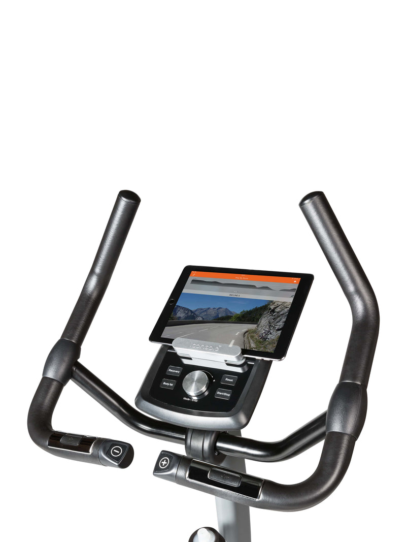 Flow Fitness DHT 2000i Upright Bike with tablet attached to the bikes tablet holder