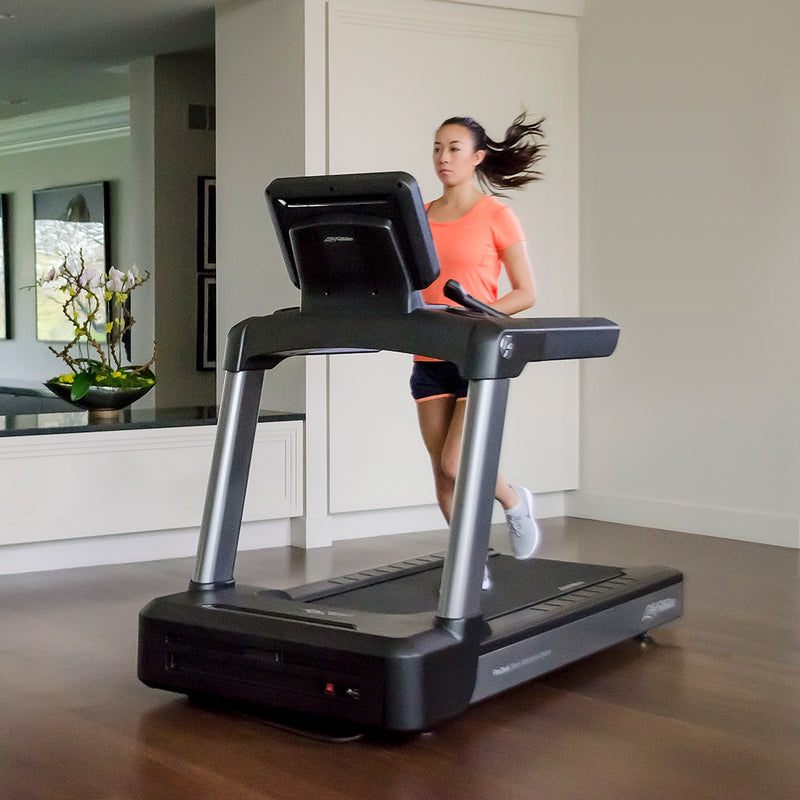 Image of a female running on a Life Fitness Club Treadmill in a home setting. Fitness Options, Online Gym Equipment Supplier and Nottinghamshire Showroom