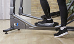 Image showing a person mounting the Life Fitness E1 Cross Trainer with one foot on the footplate.  .Fitness Options. Nottingham's leading fitness & gym equipment supplier.