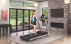 Image of a female walking on the Life Fitness F3 folding treadmill in a home setting.  Fitness Options. Nottingham's leading fitness & gym equipment supplier.