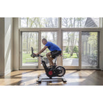 Image of a male working out on the Life Fitness IC5 indoor bike in a home setting. Fitness Options. Nottingham's leading fitness & gym equipment supplier.