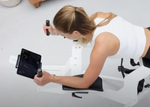 Overhead view of Icaros tablet holder and female model