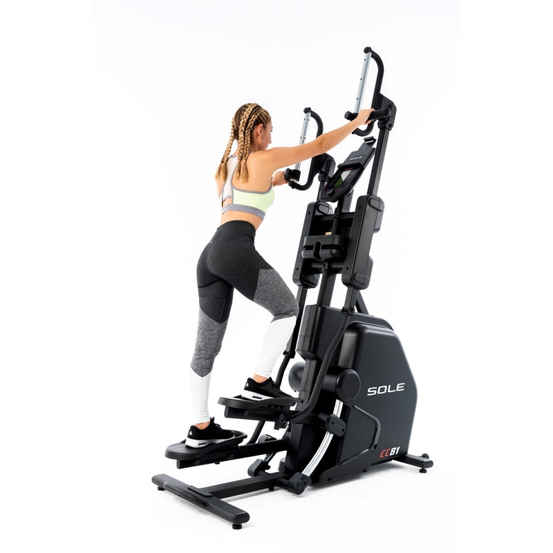 Female model on the Sole CC81 Climber slightly angled so you can see more of the rear of the machine where you mount the foot plates. Fitness Options, Online Gym Equipment Supplier and Nottinghamshire Showroom